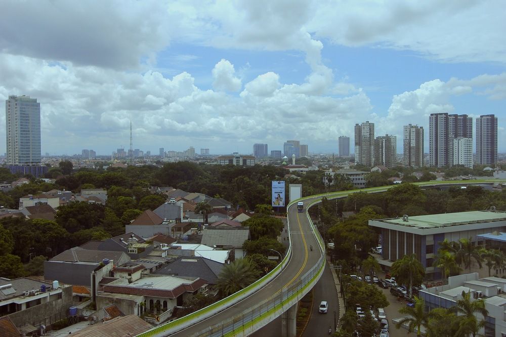 The elevated road curves in dense residential cities