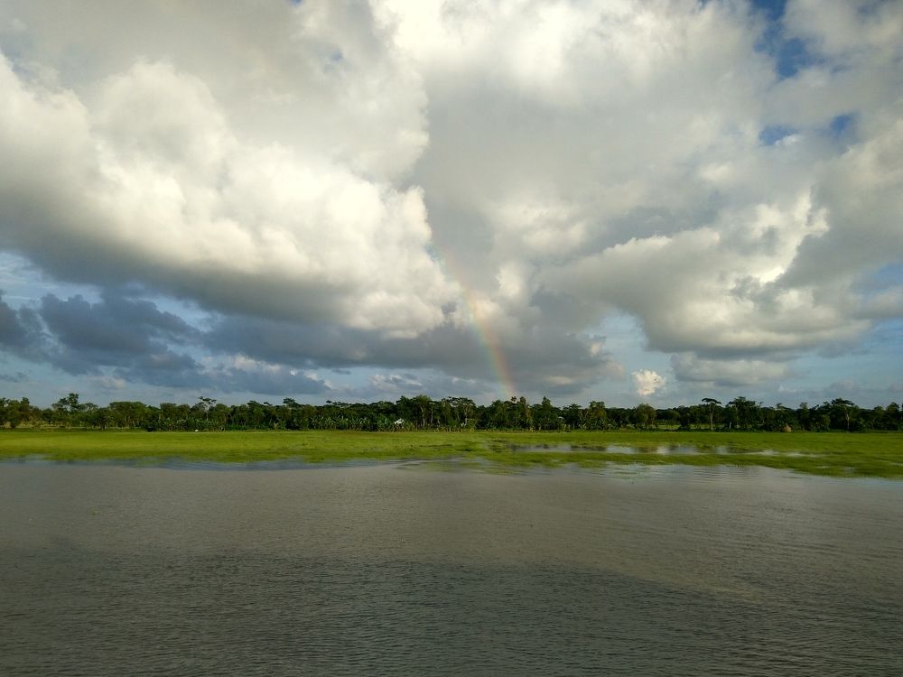 Rainbow under clouds