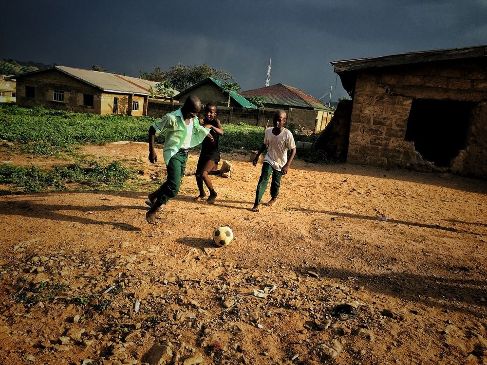 Picture of young African children playing street soccer