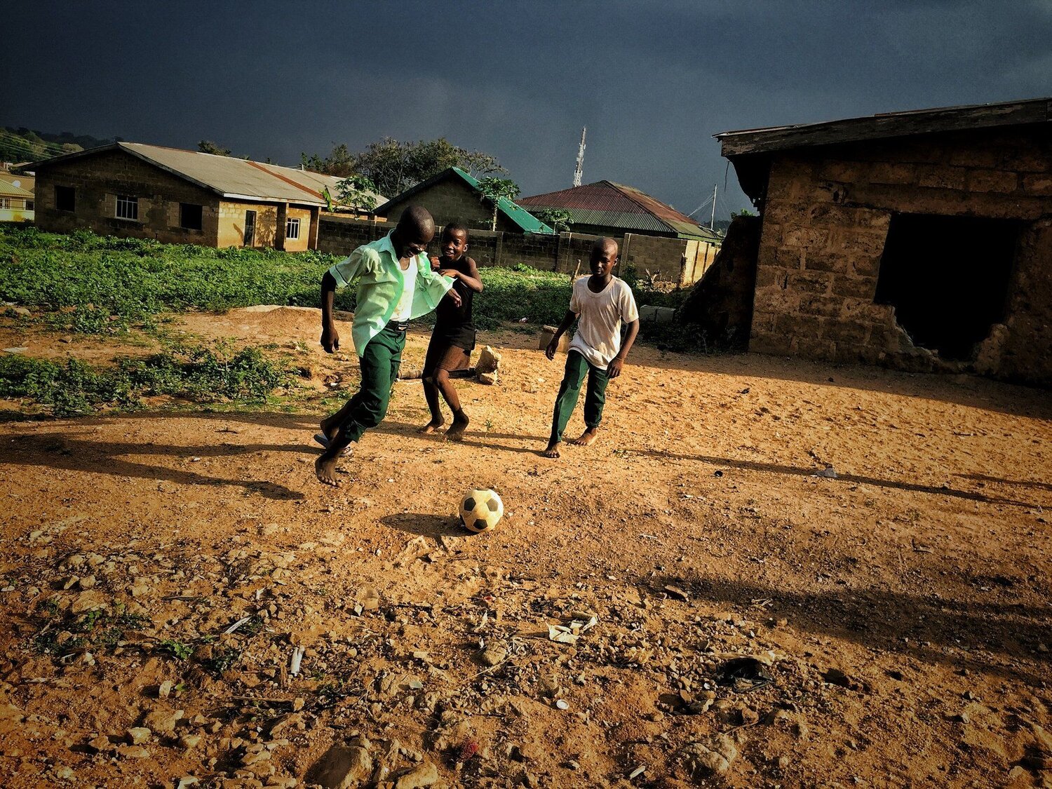 Picture of young African children playing street soccer