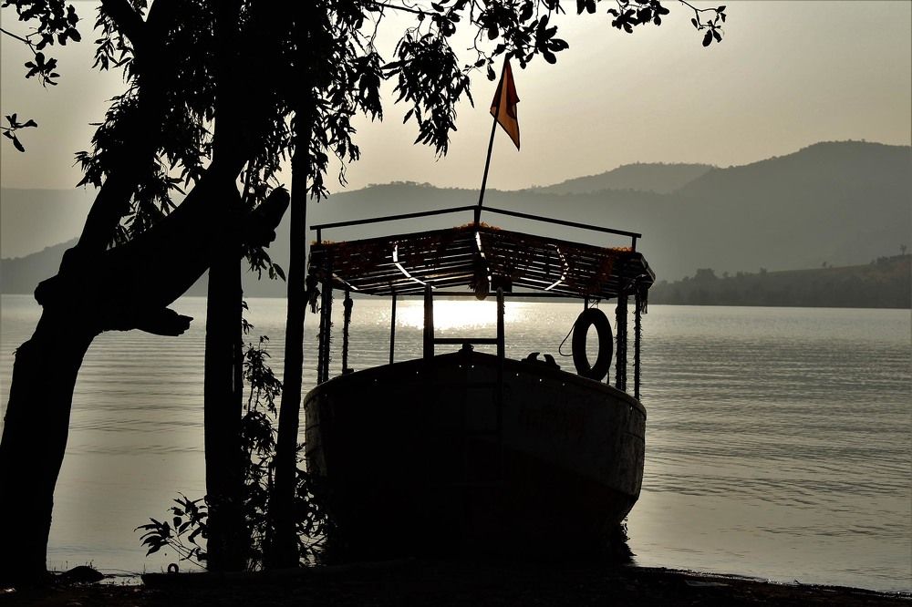 Boat on the shore of Koyana river at the time of sunset.