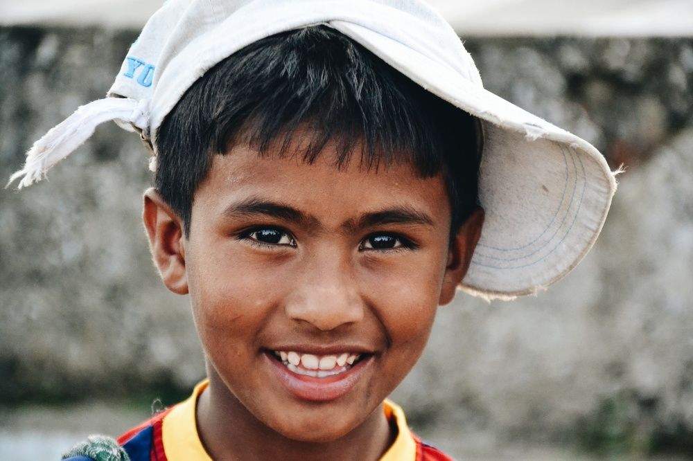 Potraits of mountain children of India wearing a cap