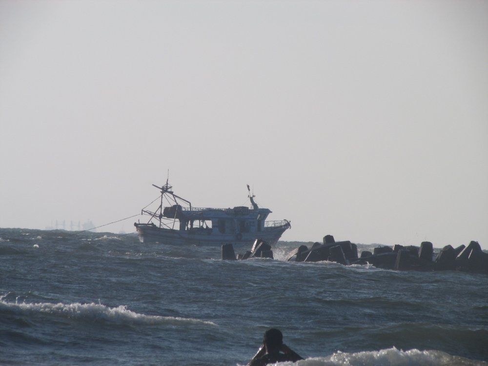 a man swimming near a boat