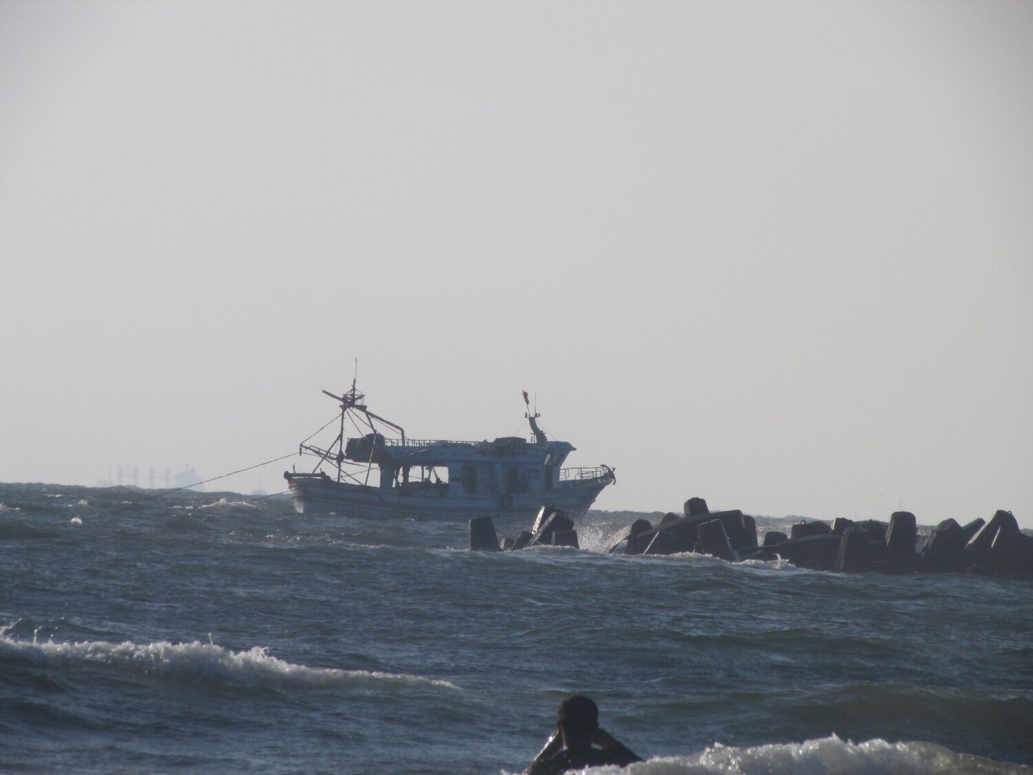 a man swimming near a boat