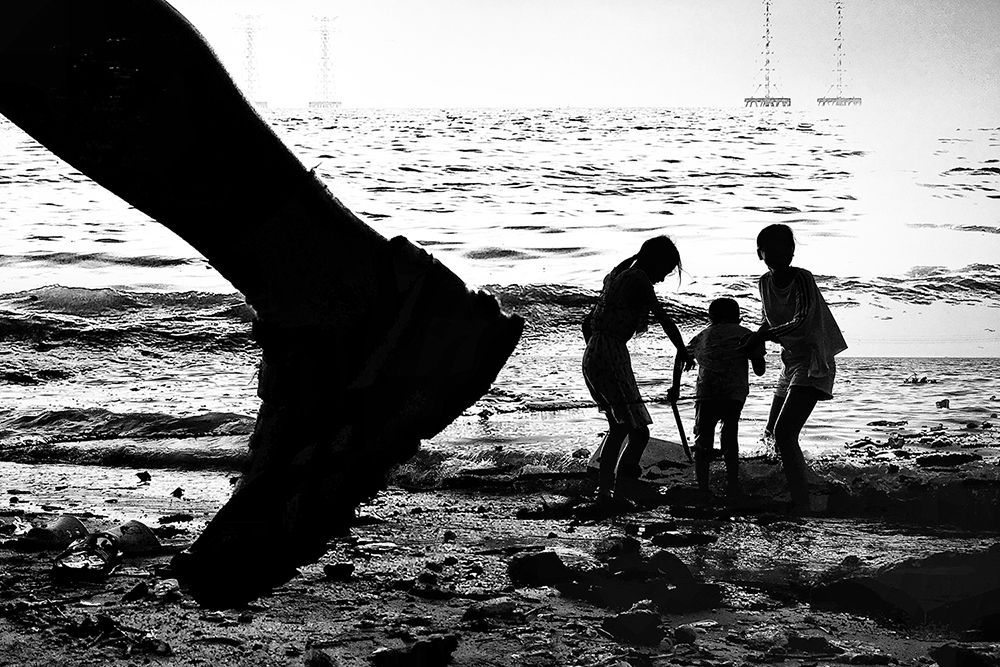 Four children playing on the beach