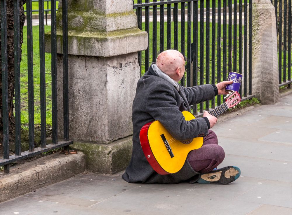 A Homeless Guitarist Begging For His Daily Bread