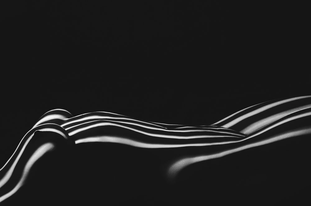 Beautiful body girl in the white line on a black background.