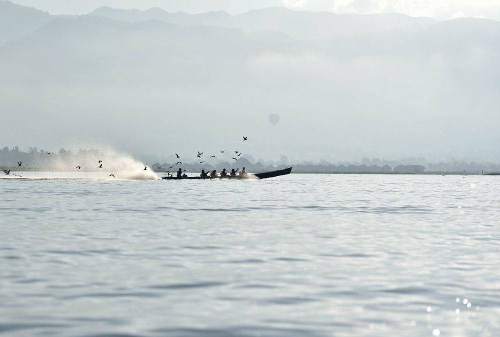 An early morning a boat crossing the Inle Lake