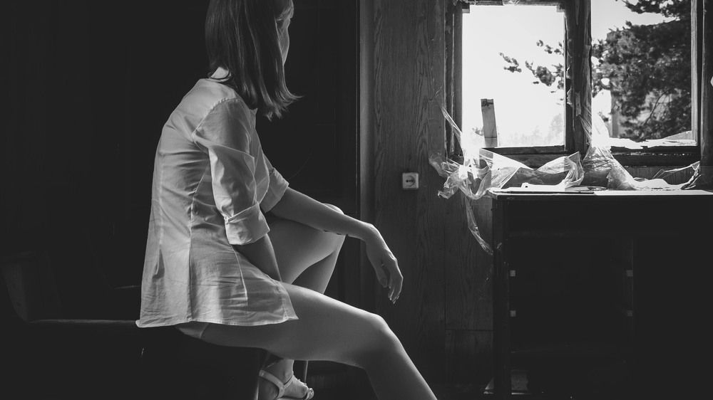 Одна возле окна