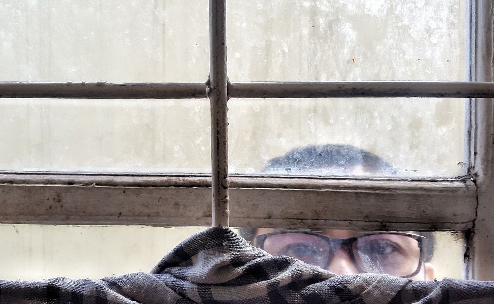 Man behind window