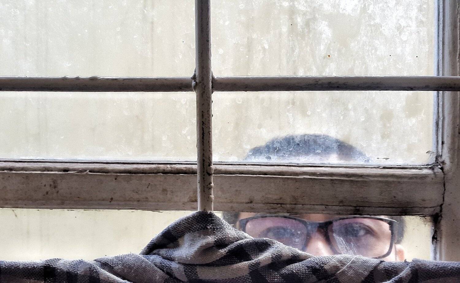 Man behind window