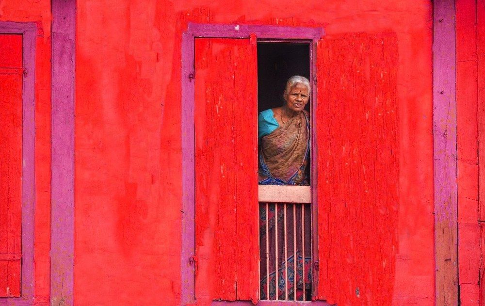 Morning at 8 am old women watching outside of home
