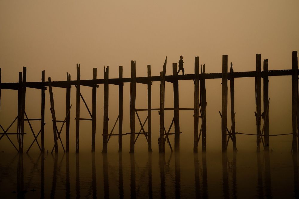 A man walking on U bein bridge