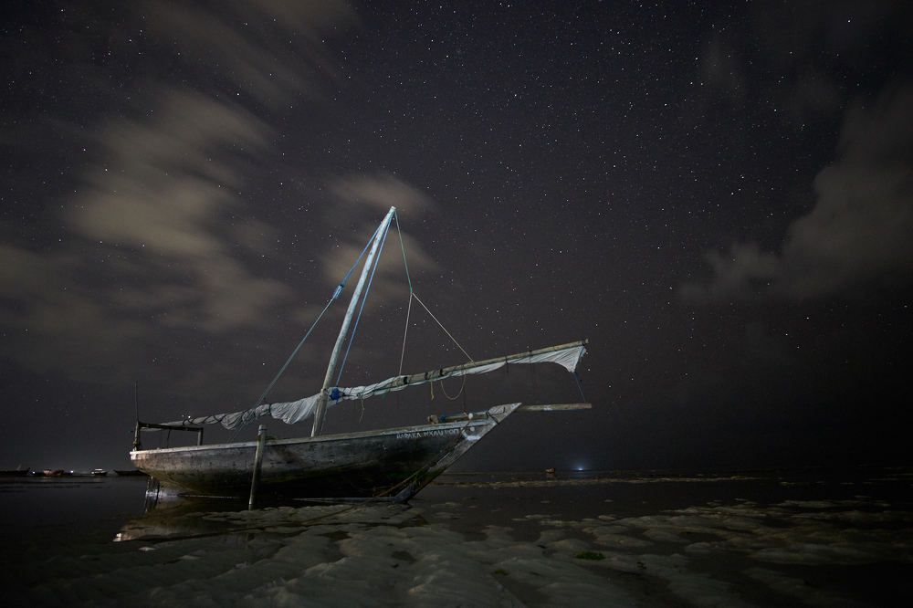 Starry sky over a fishing boat