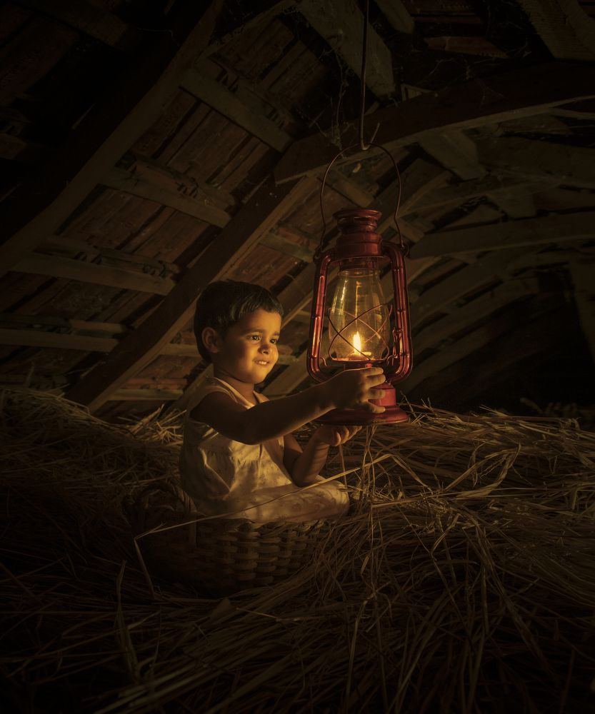 Little girl curious on vintage lamp