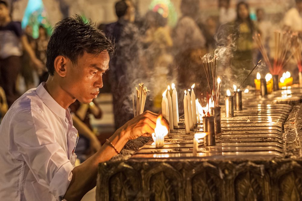 Yangon, Myanmar. The man prays in Shvedagon Pagoda.