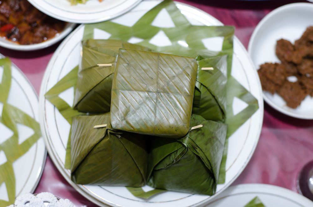eat traditional Aceh rice wrapped in banana leaves