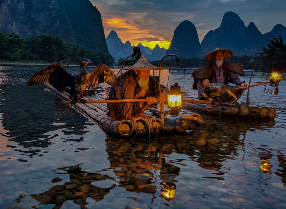 Old fishermen on sunset