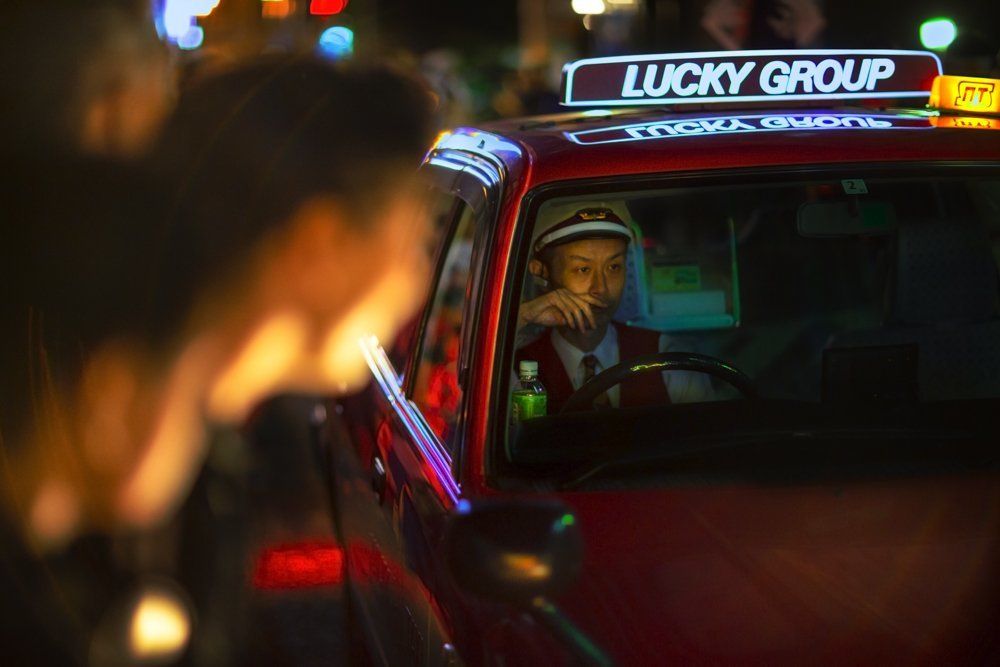 A taxi in the crowd of downtown