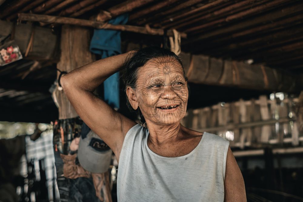 Woman with facial tattoos in Myanmar