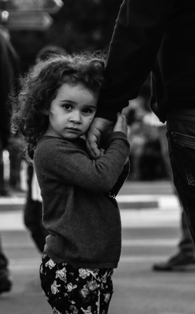 Little girl holds her father's hand