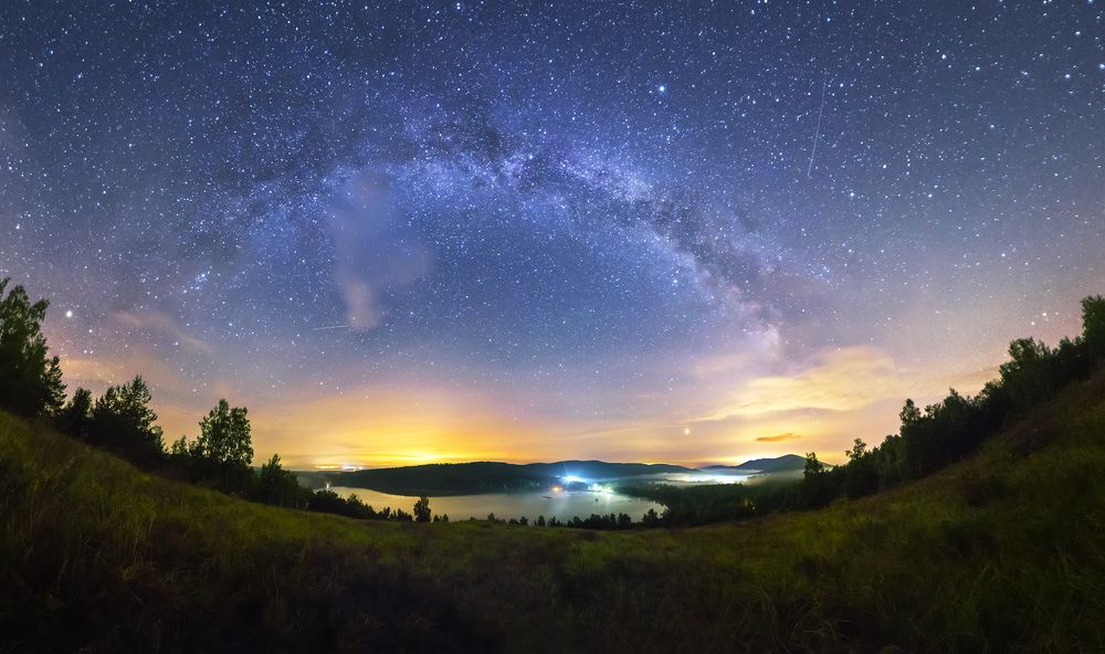 Домики у озера меж гор под млечным путём