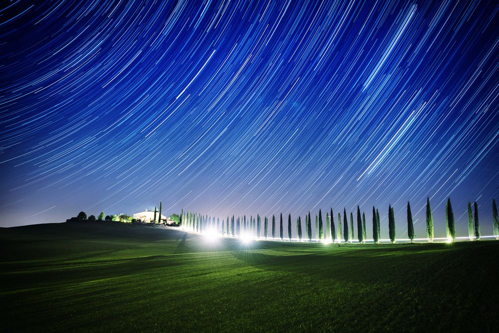 Tuscany landscape with star tracks