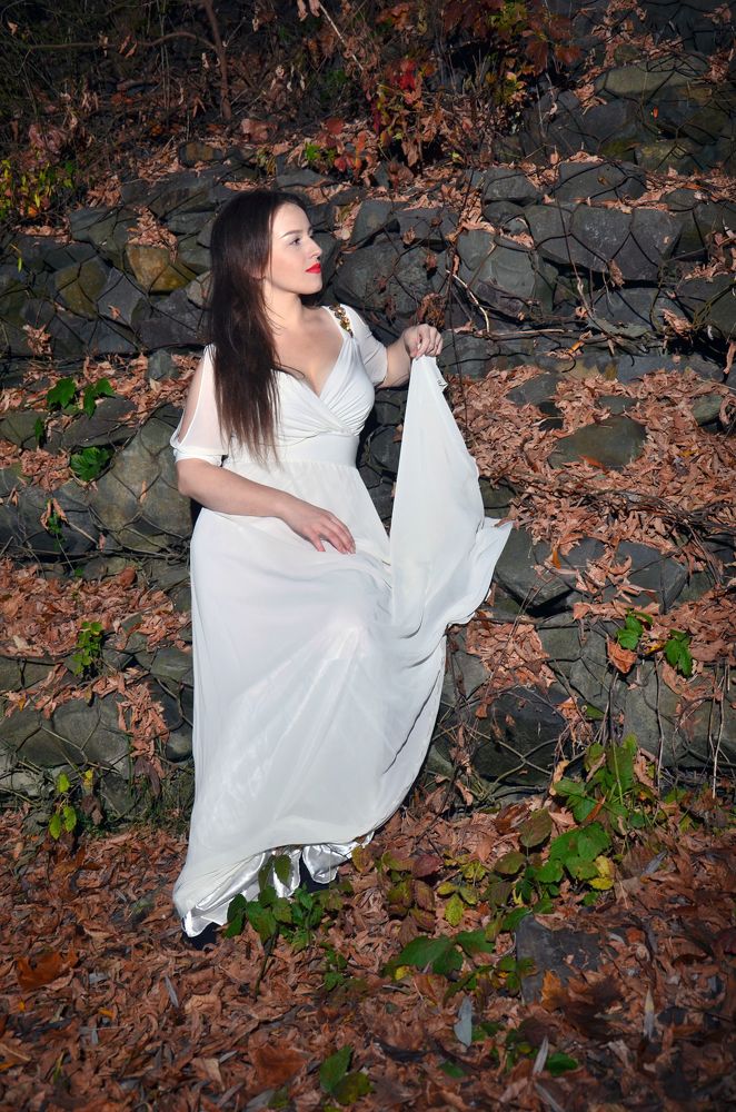 Девушка в платье около камней