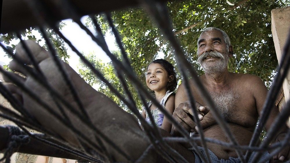 With a serious smile