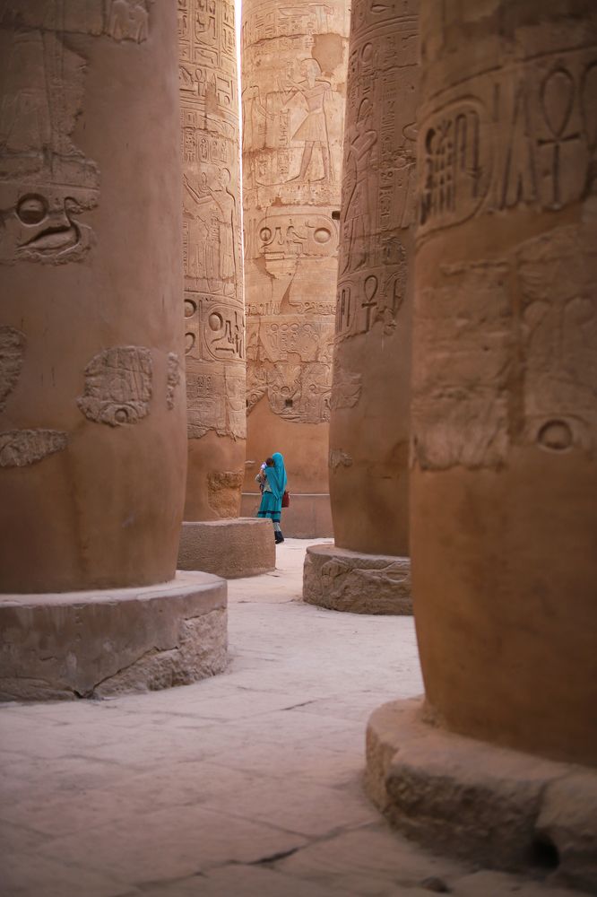 Egyptian girl and baby between Karnak's columns
