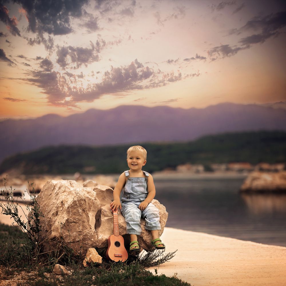 boy on a beach at sun set