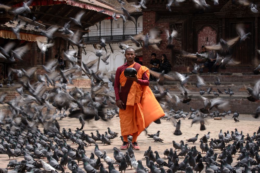 Nepalese Buddhist monk with alms bowl