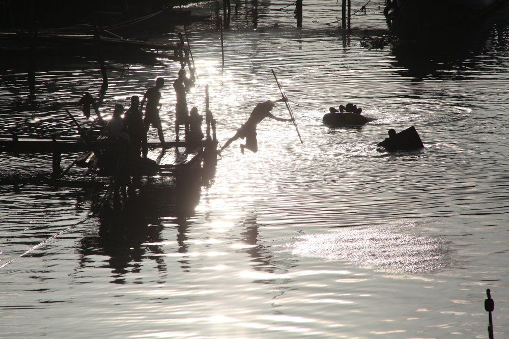 school holidays, children catch fish with spears