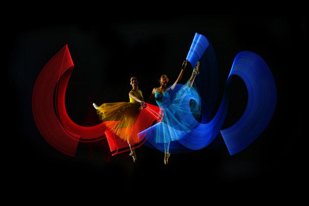 duo balerinas dance with lighting