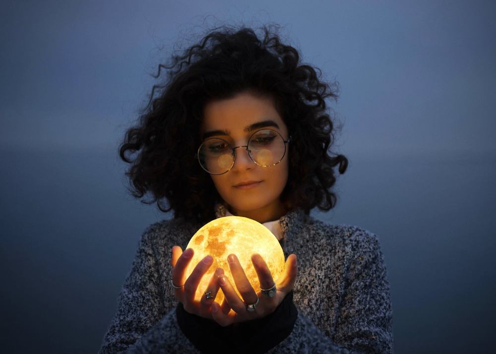 Girl holding the Moon