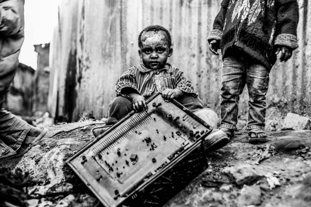 The boy playing with the TV remains