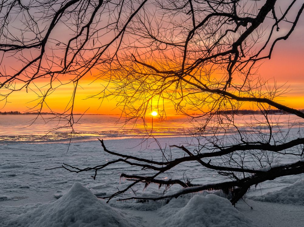 A sunset over a frozen river