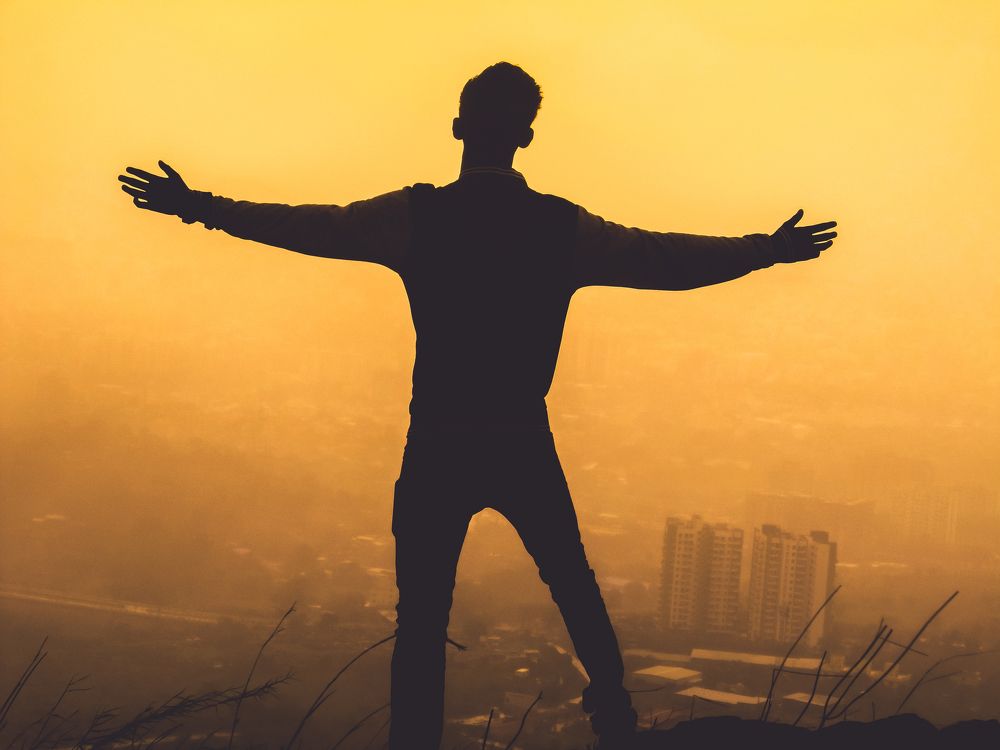 Standing alone in foggy sunset