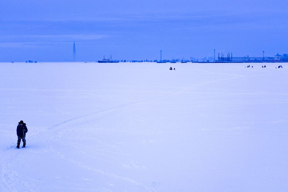 The fisherman comes back from winter fishing on ice