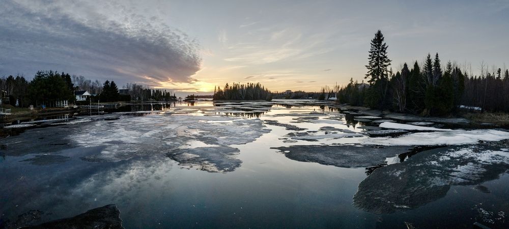 A sunset across ice formations in an inlet