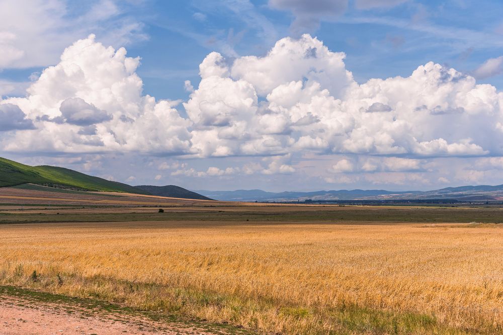 Fields and hills vs. sky and clouds