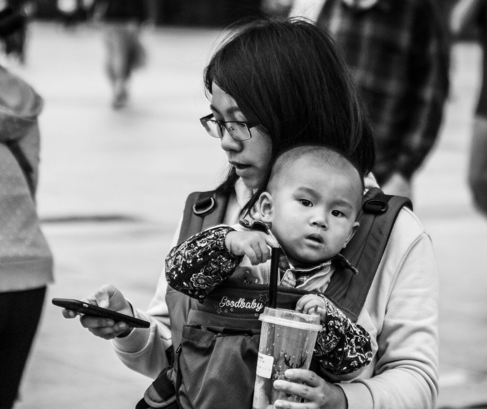A somewhat disconnected triangle of mom, child, photographer