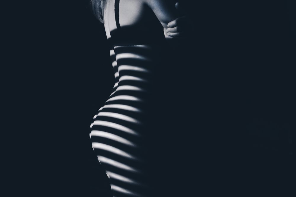 Beautiful body girl in the white line on a black background.