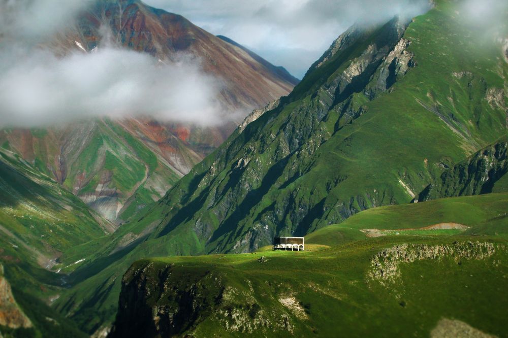 Friendship Arch in Kazbegi and magic mountains.