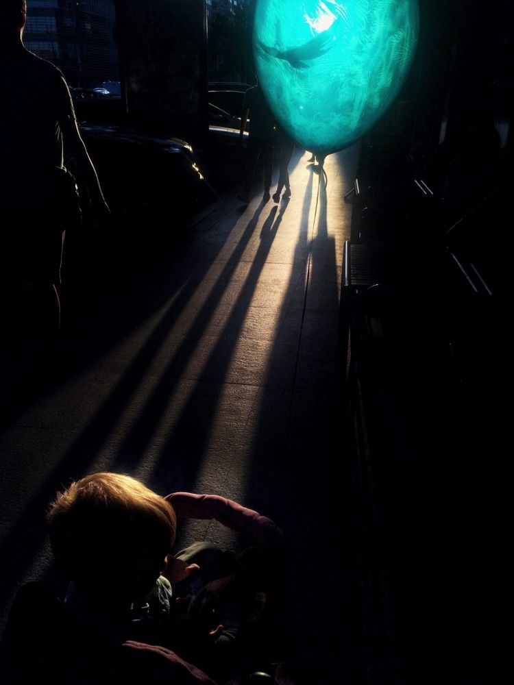 The boy with a blue ballon