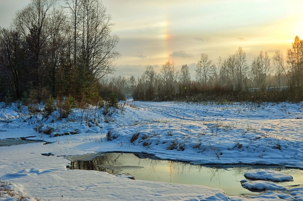 Reflection. Winter rainbow