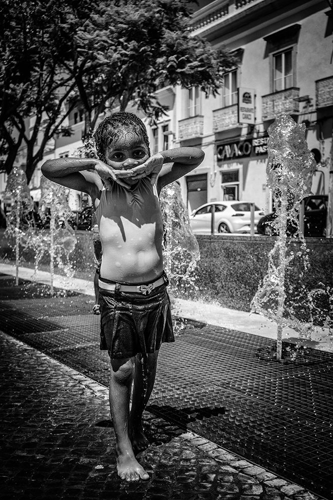 Children playing with water jet