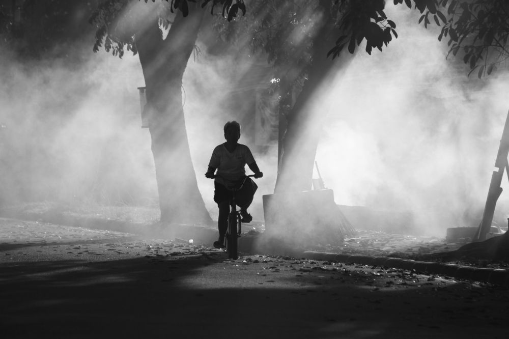 cyclists surrounded by smoke