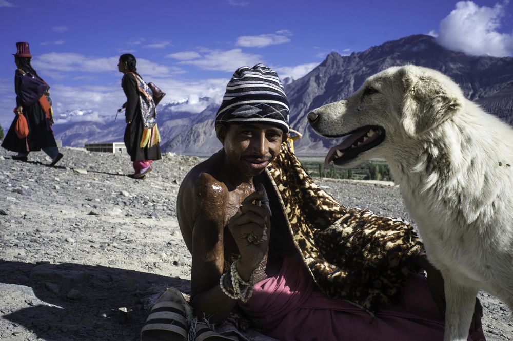 scared beggar with dog , Disket, Ladakh