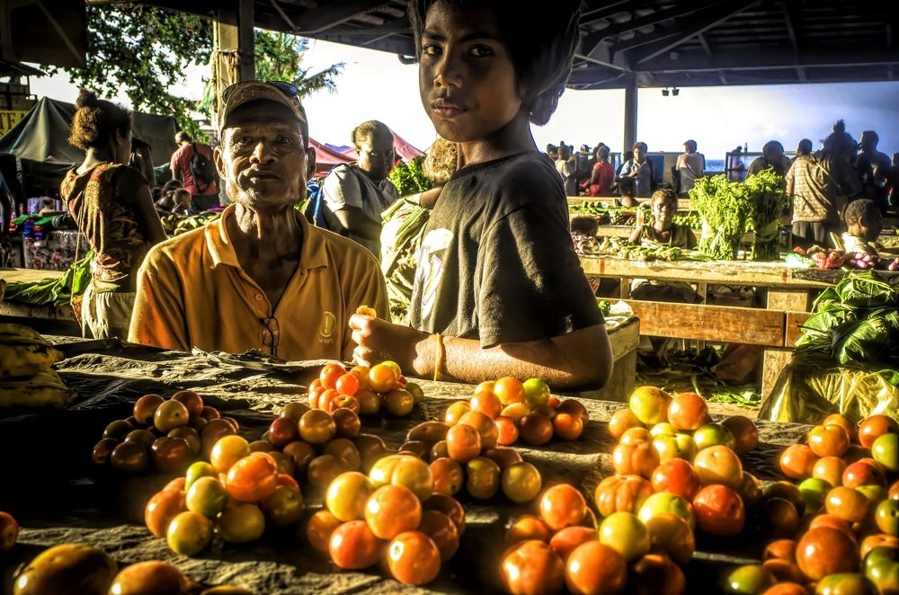 boy and grandfather at the market , Honiara , 2018